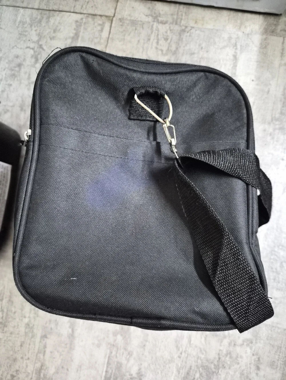This black Tournamax duffel bag features a prominent logo and secured  pockets